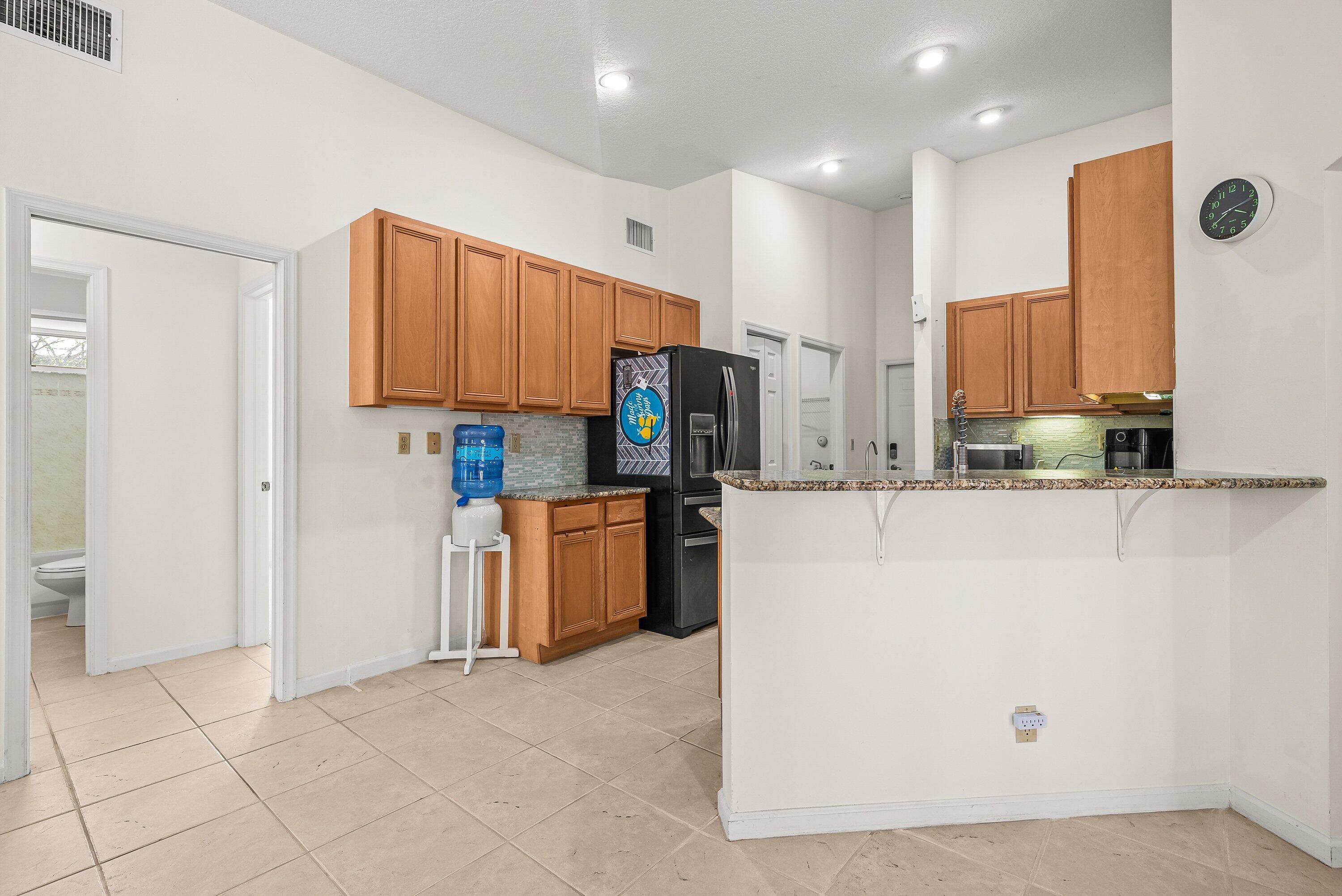 18098 93rd Road North The Acreage, FL 33470 - Photo 13 of 60 a kitchen with stainless steel appliances a refrigerator and a stove