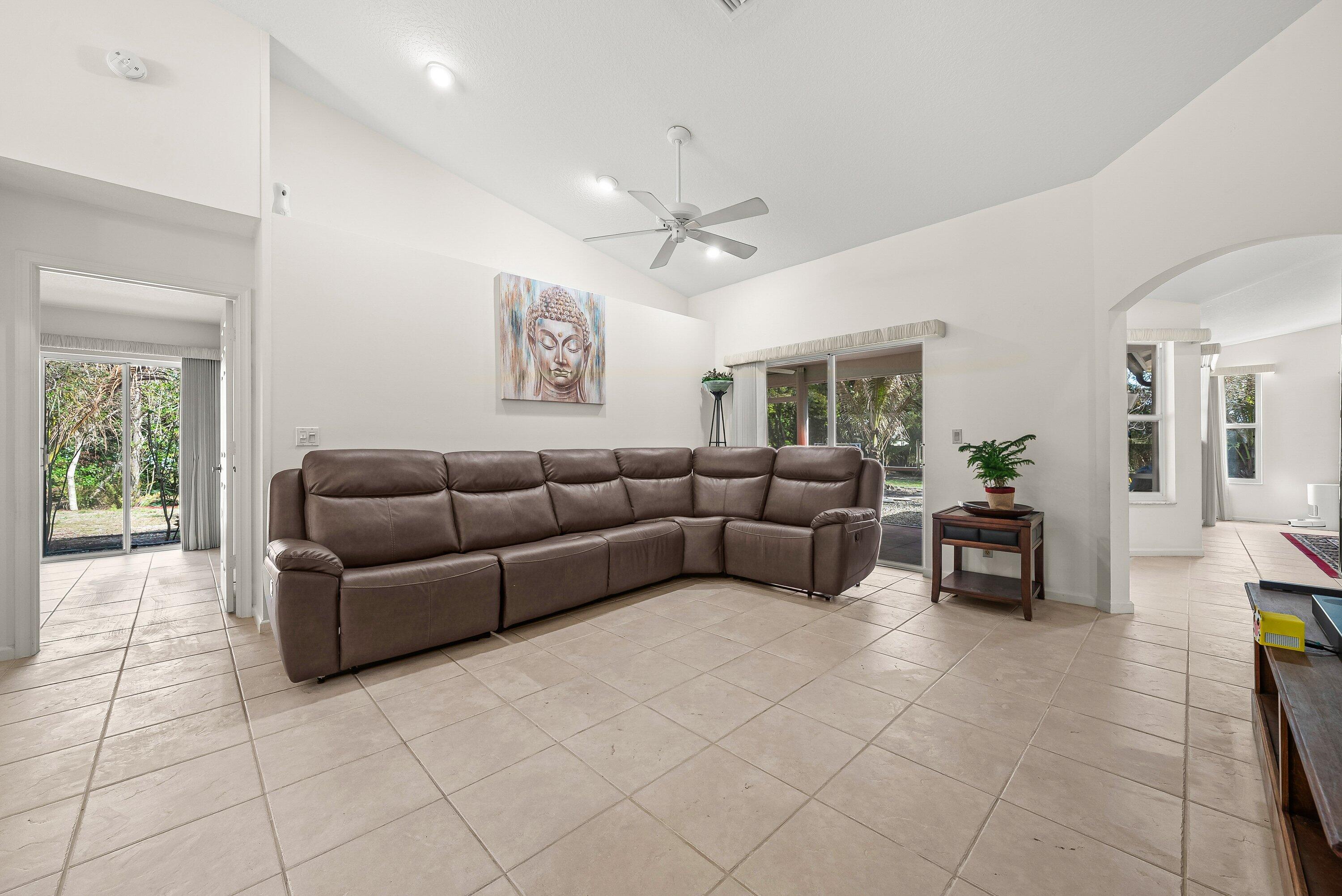 18098 93rd Road North The Acreage, FL 33470 - Photo 16 of 60 a living room with furniture and a chandelier