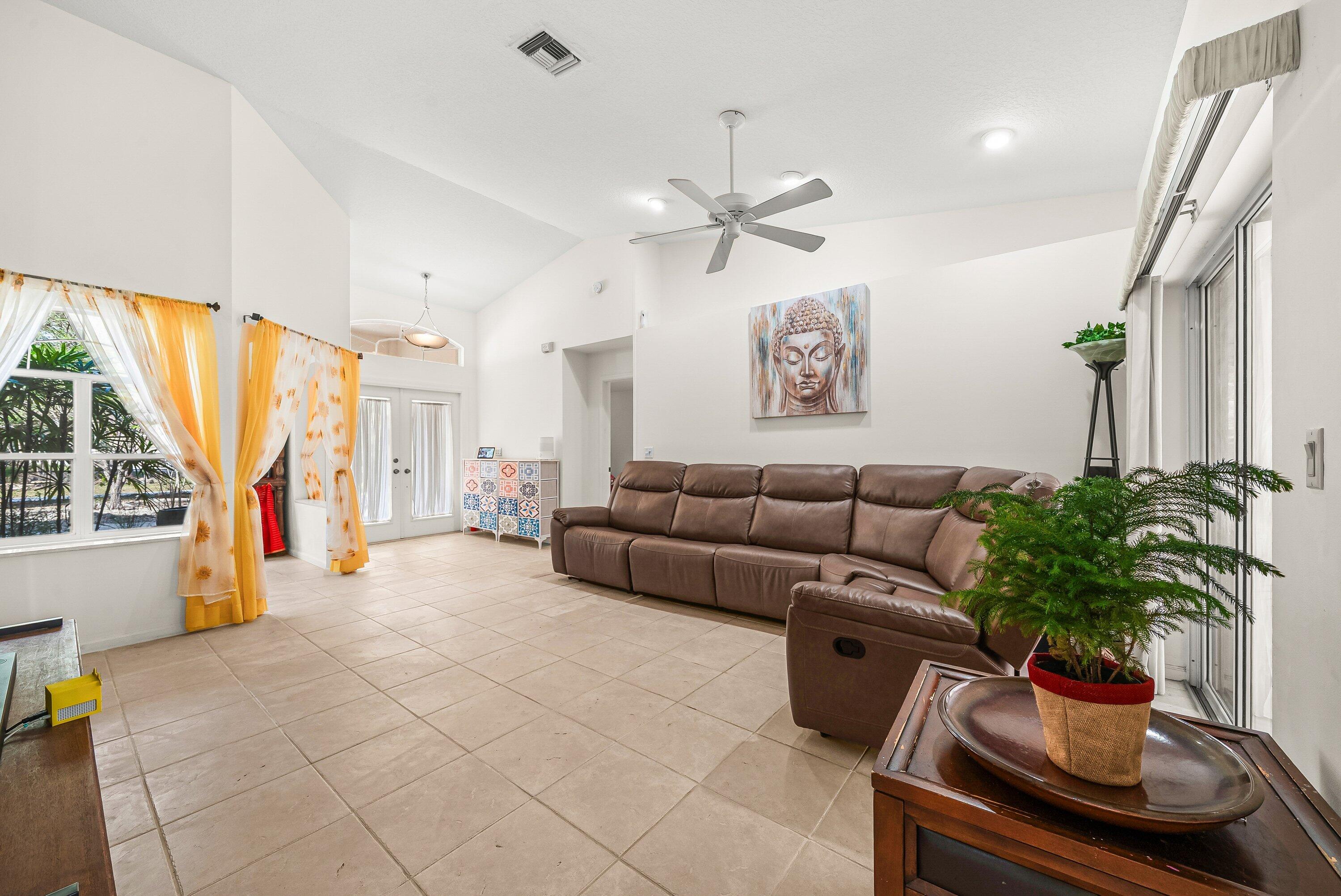18098 93rd Road North The Acreage, FL 33470 - Photo 17 of 60 a living room with furniture and a large window