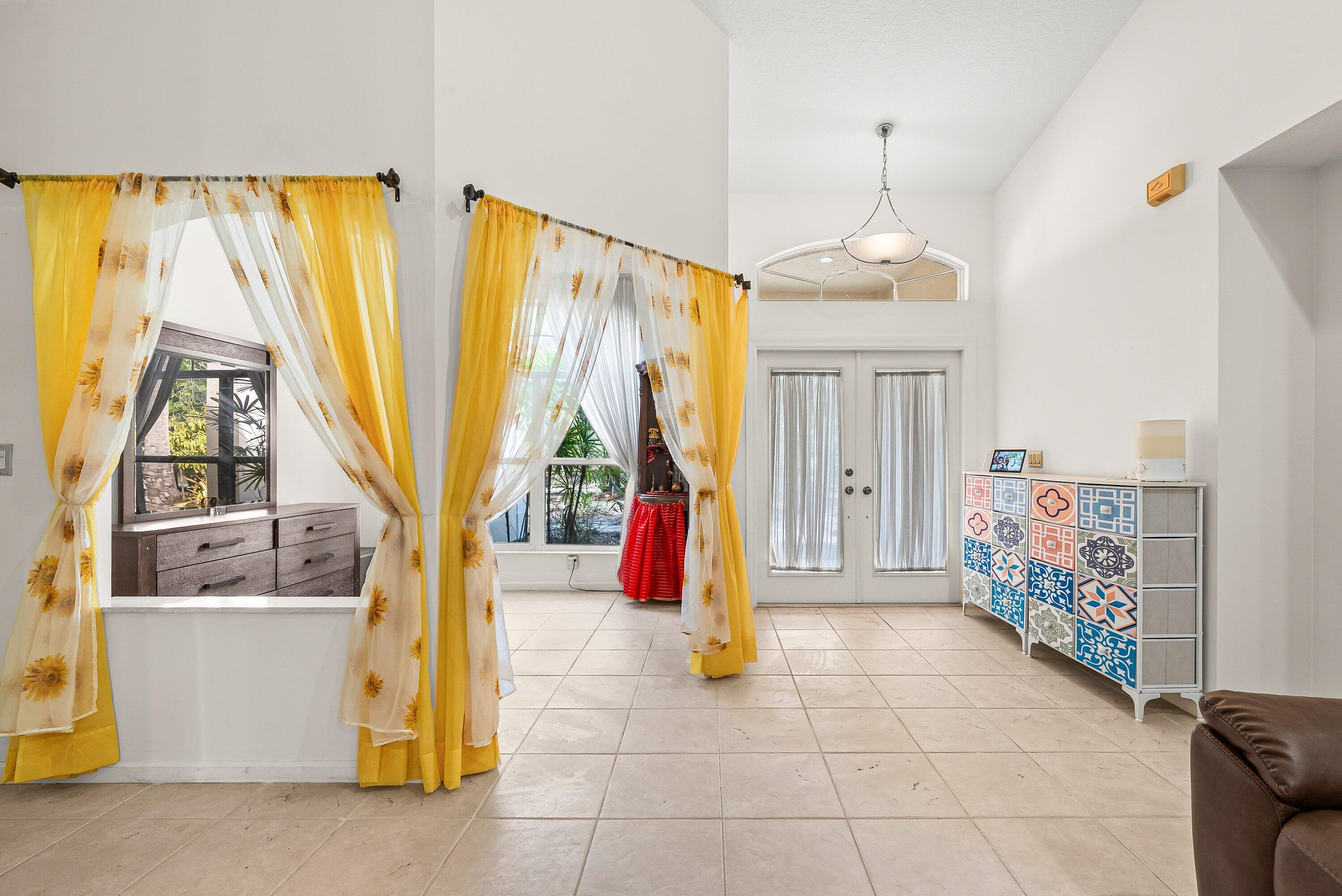 18098 93rd Road North The Acreage, FL 33470 - Photo 18 of 60 a living room with furniture and a chandelier
