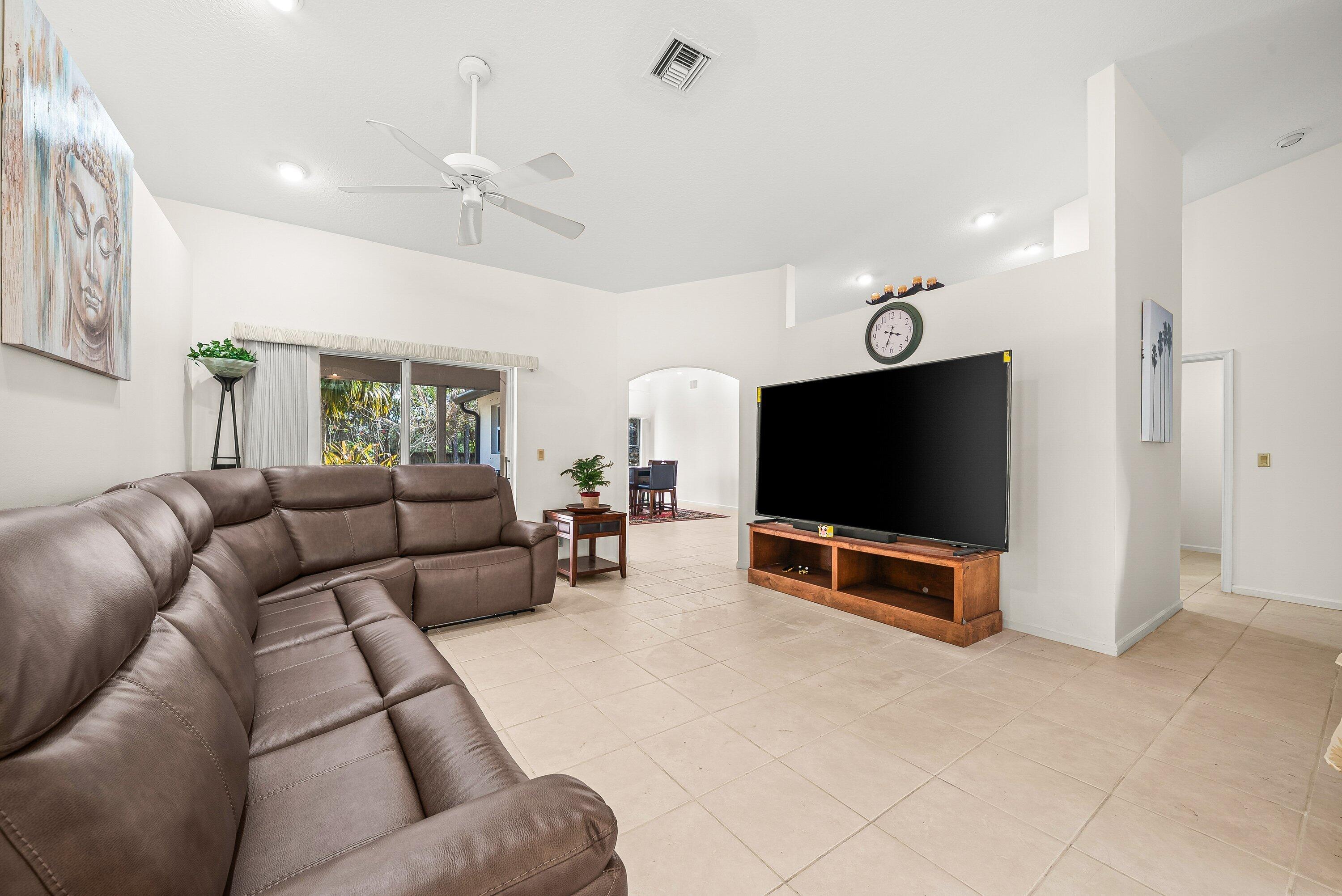18098 93rd Road North The Acreage, FL 33470 - Photo 19 of 60 a living room with furniture and a flat screen tv