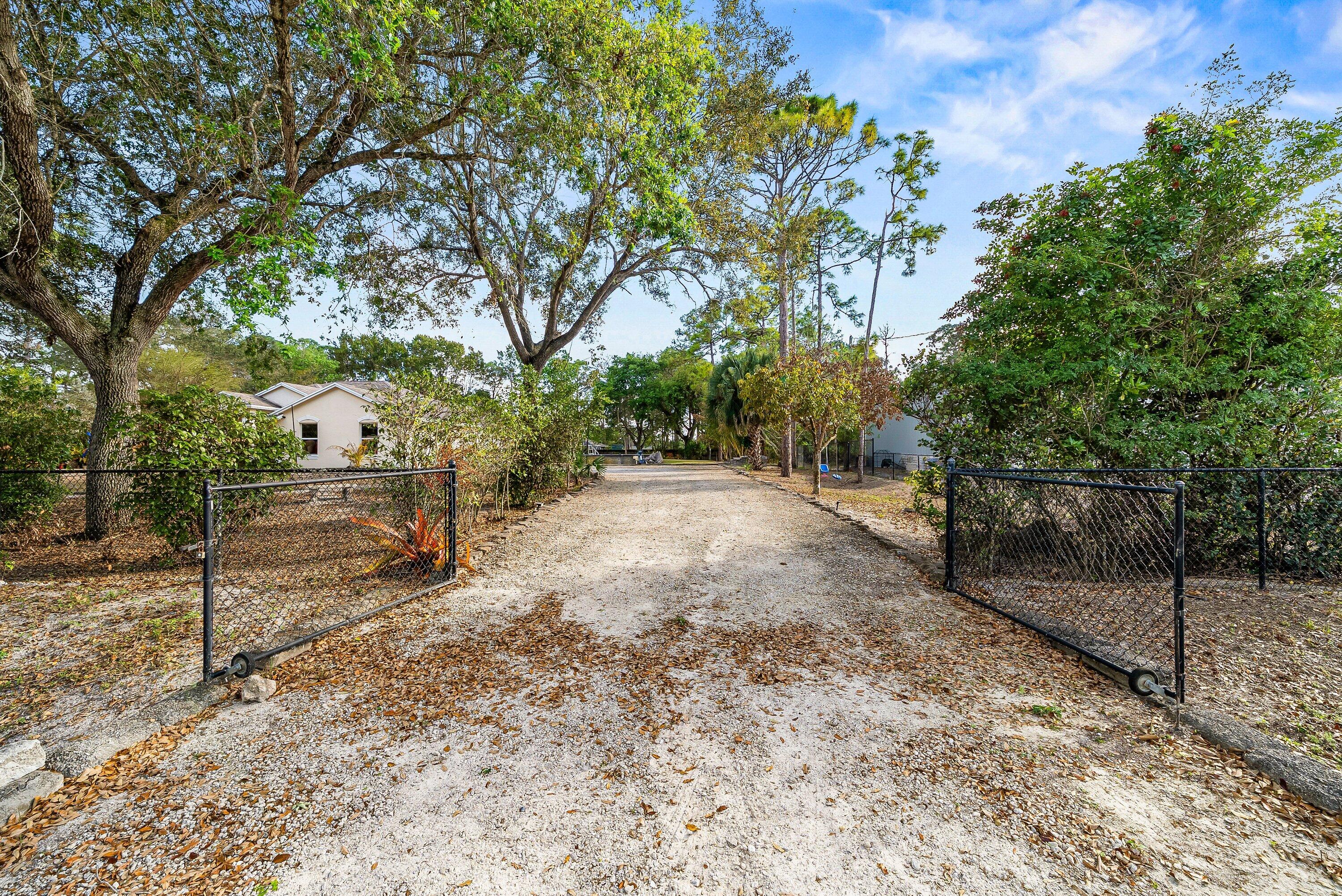 18098 93rd Road North The Acreage, FL 33470 - Photo 2 of 60 a view of a yard with wooden fence