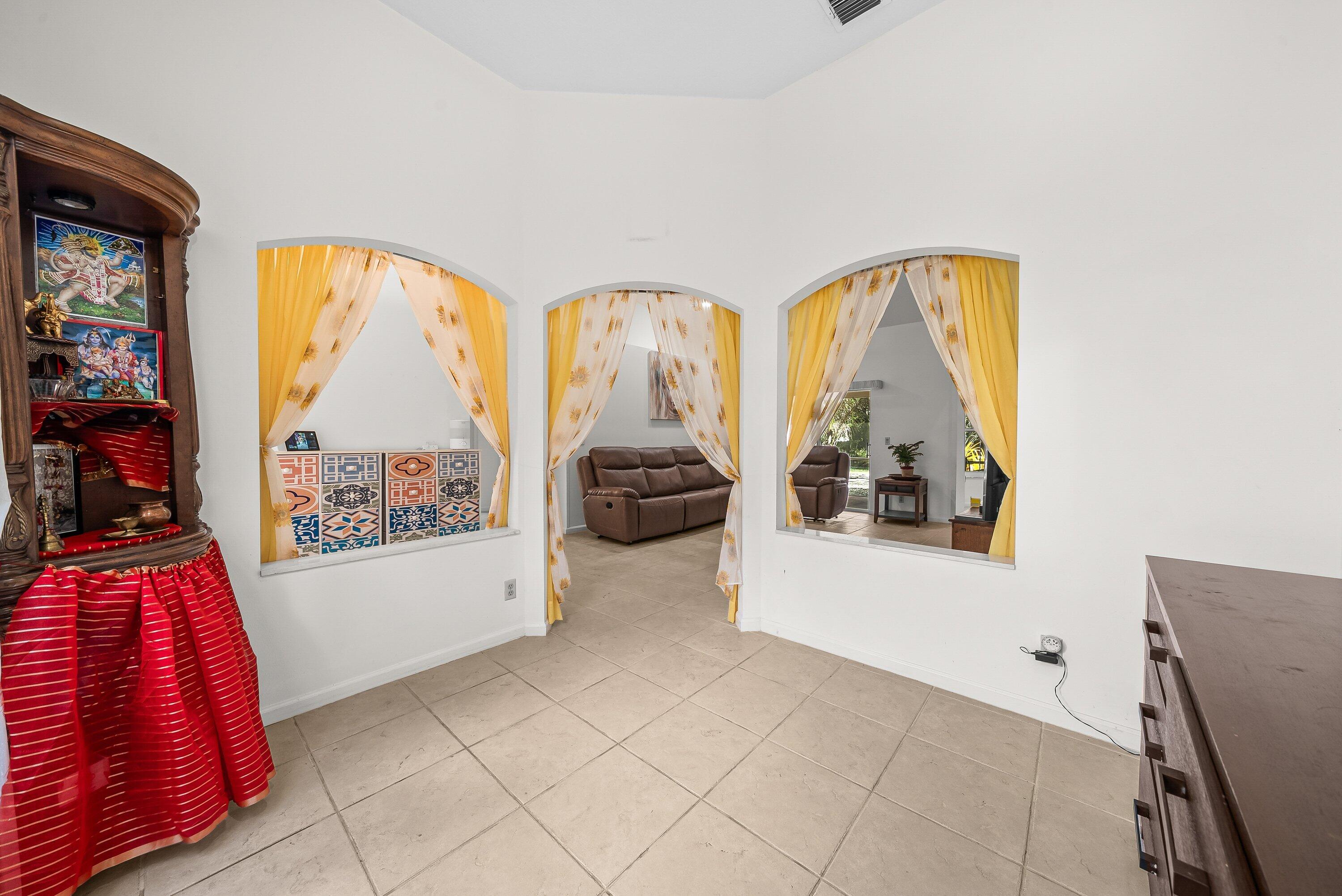 18098 93rd Road North The Acreage, FL 33470 - Photo 21 of 60 a living room with furniture and a large window