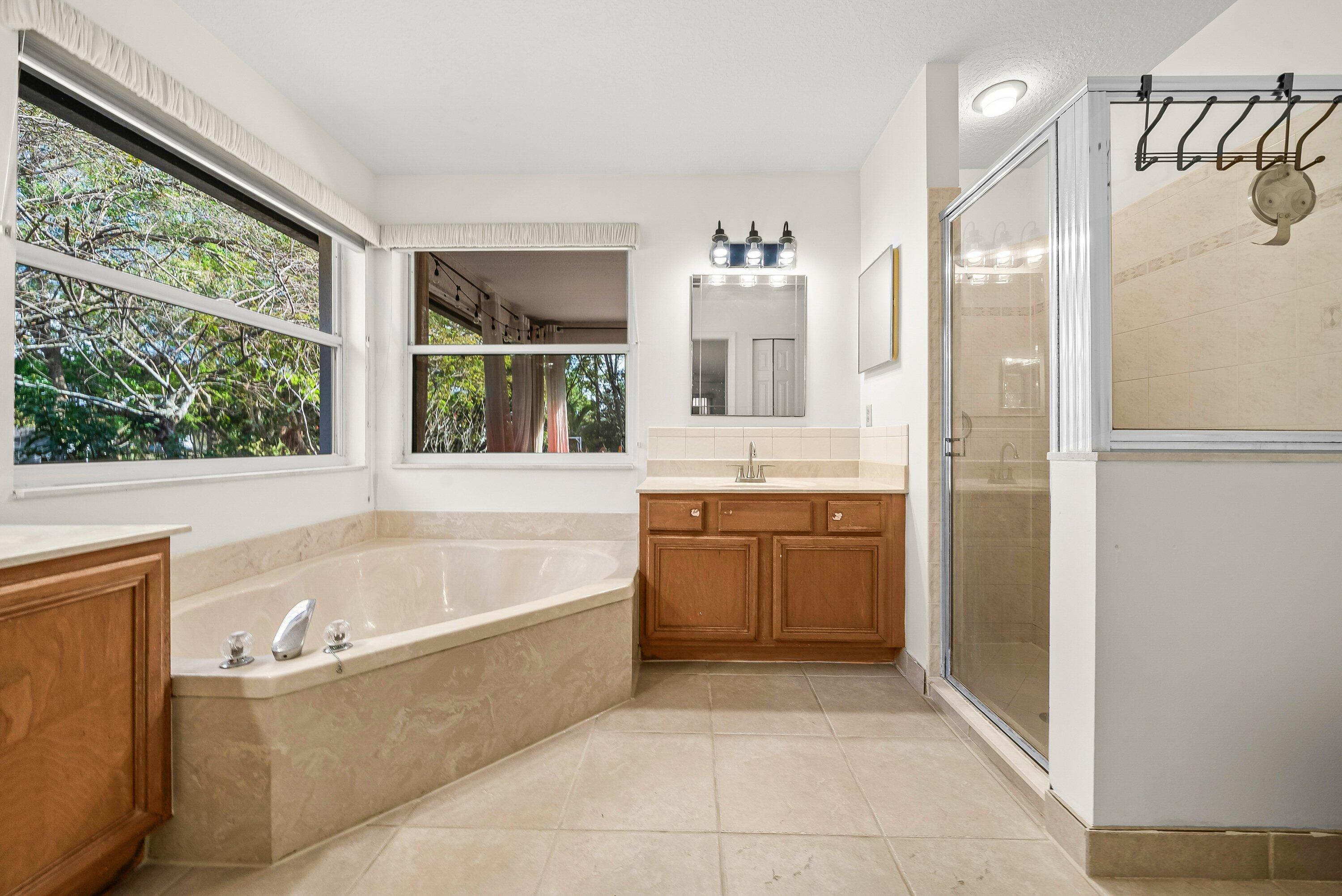 18098 93rd Road North The Acreage, FL 33470 - Photo 24 of 60 a bathroom with a bathtub and a sink