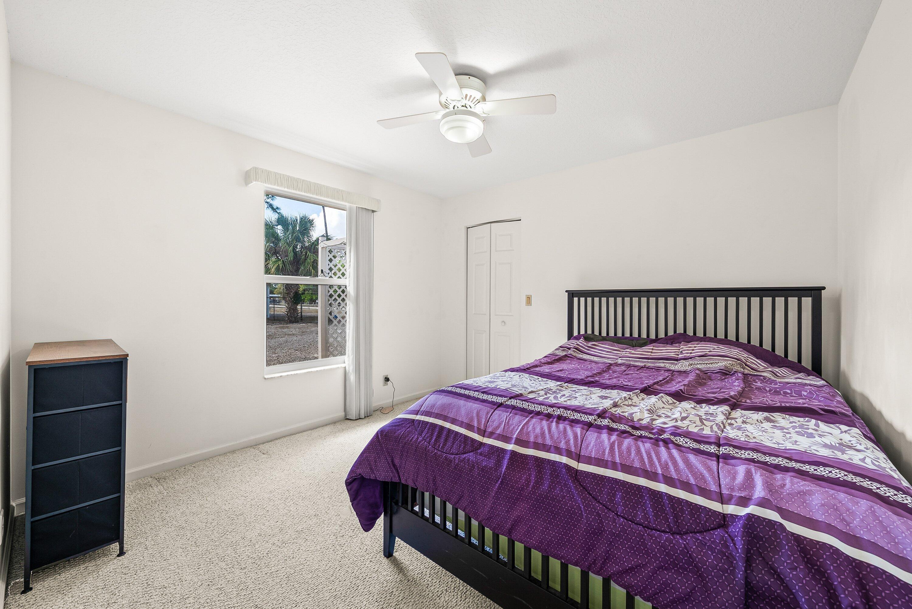 18098 93rd Road North The Acreage, FL 33470 - Photo 30 of 60 a bedroom with a bed and window
