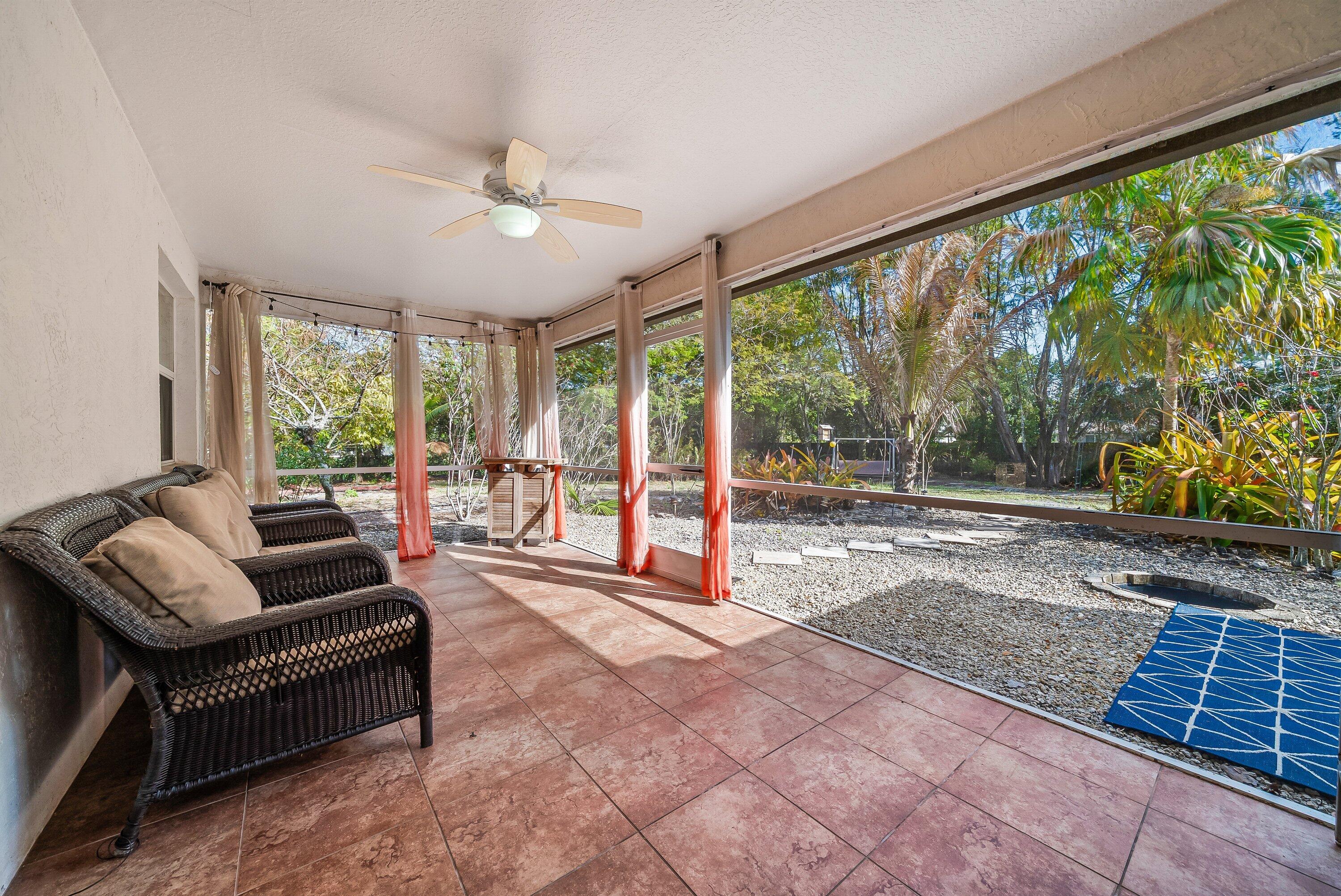 18098 93rd Road North The Acreage, FL 33470 - Photo 32 of 60 a living room with furniture and a large window