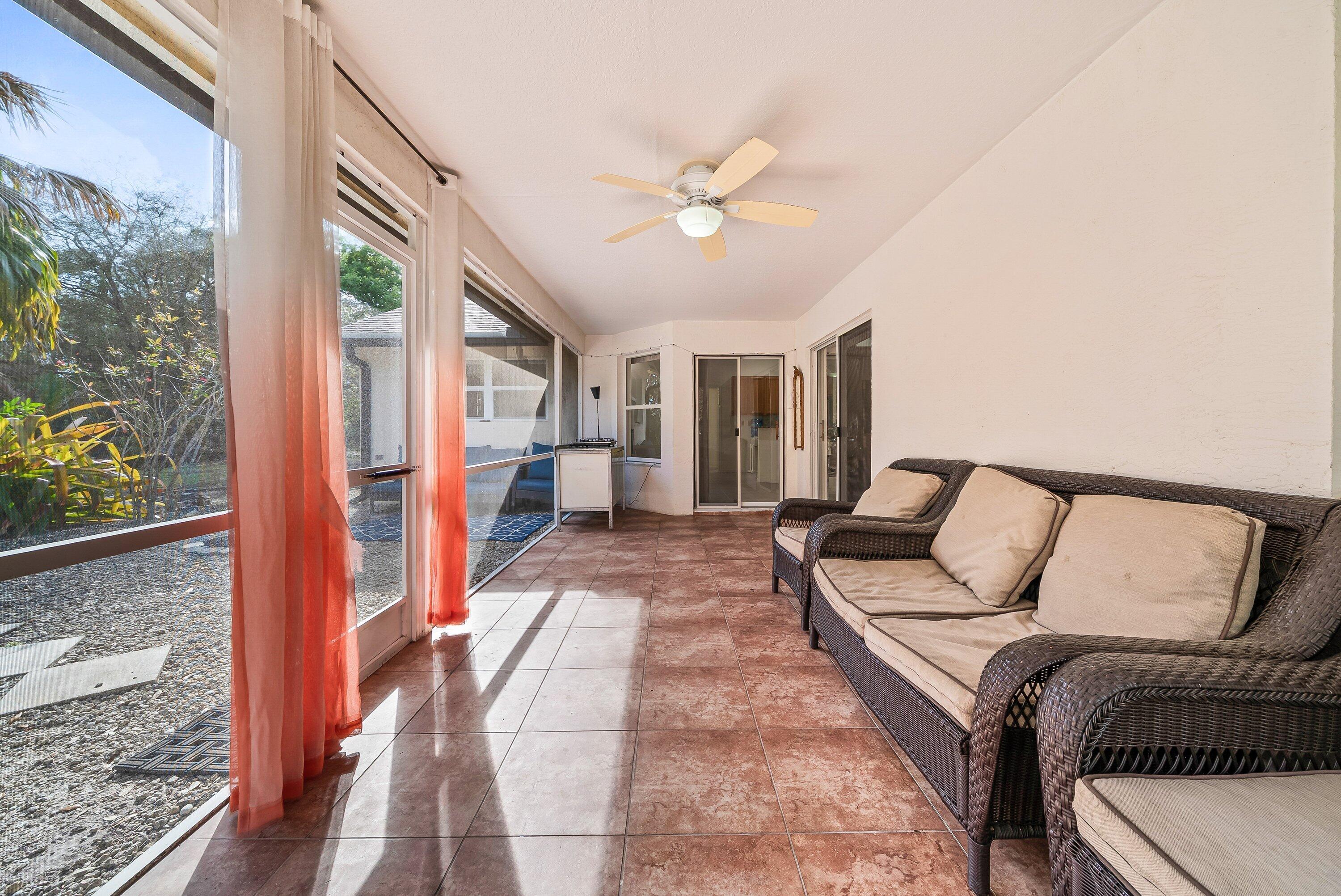 18098 93rd Road North The Acreage, FL 33470 - Photo 33 of 60 a bedroom with a large bed and a chandelier