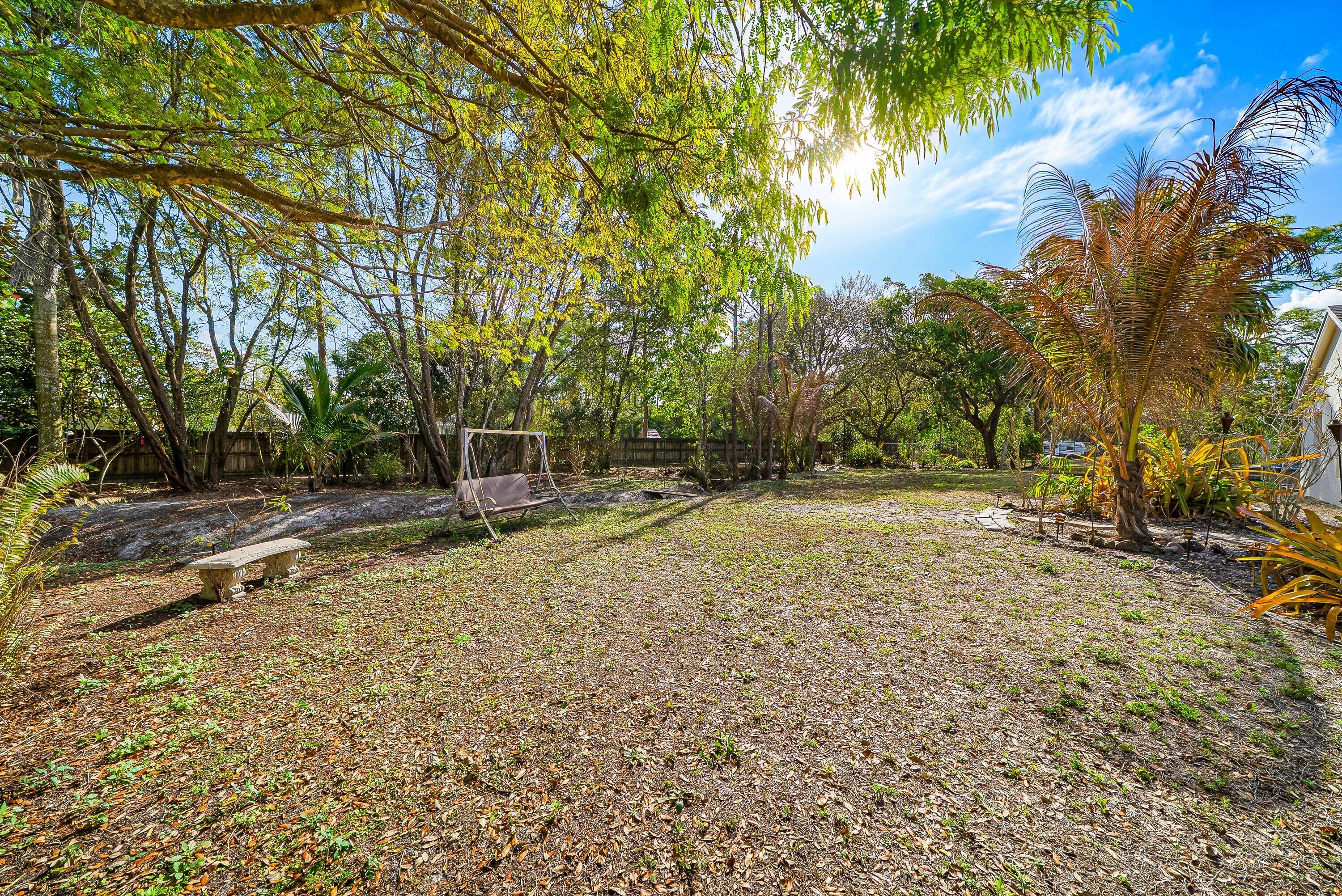 18098 93rd Road North The Acreage, FL 33470 - Photo 39 of 60 a backyard of a house with lots of green space