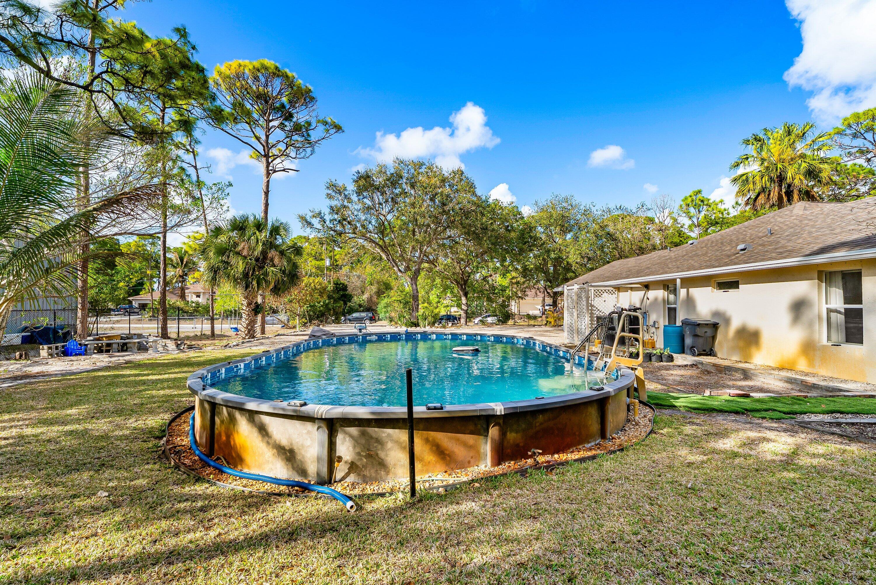 18098 93rd Road North The Acreage, FL 33470 - Photo 47 of 60 swimming pool with outdoor seating and yard