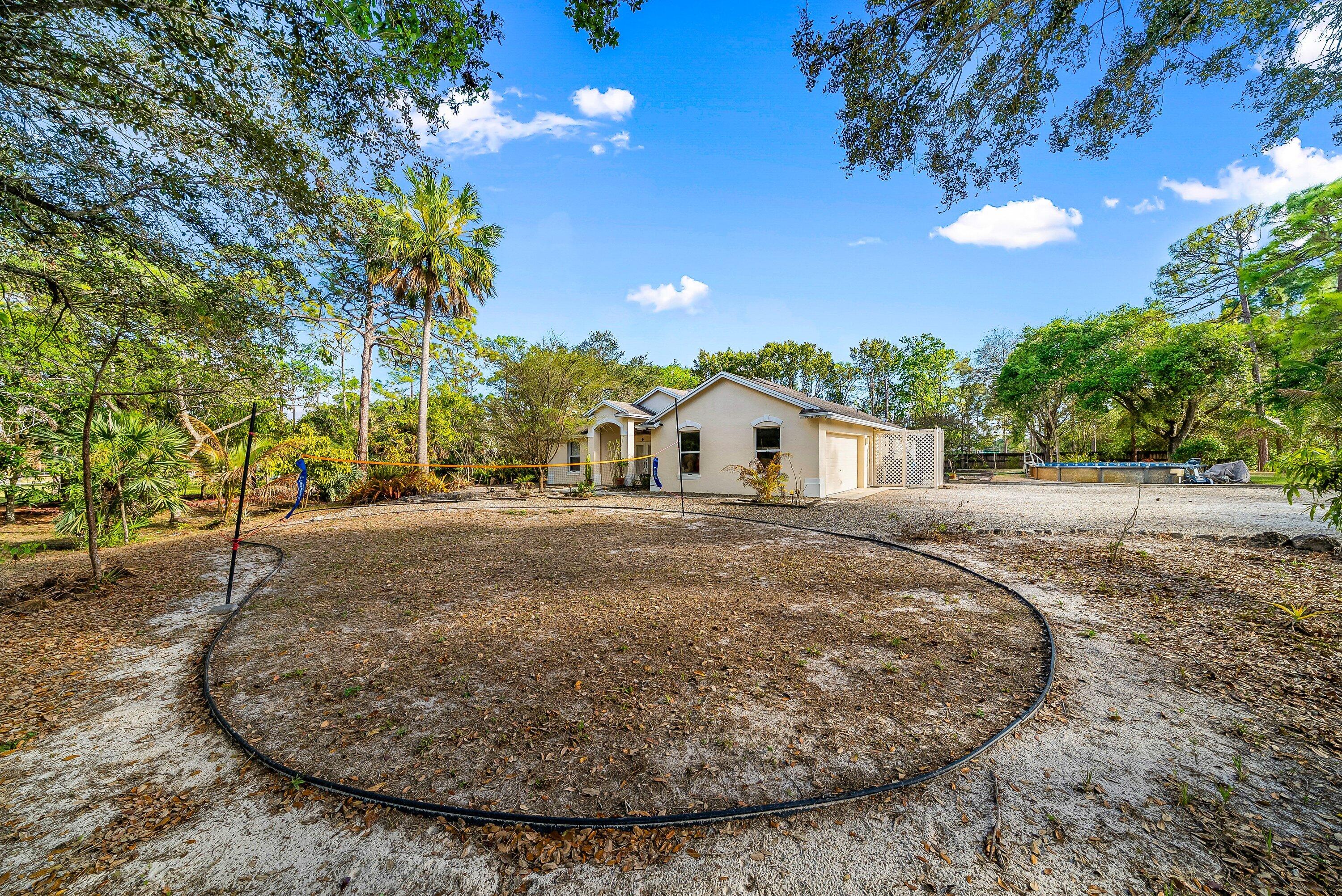 18098 93rd Road North The Acreage, FL 33470 - Photo 7 of 60 a view of a house with a yard and street view