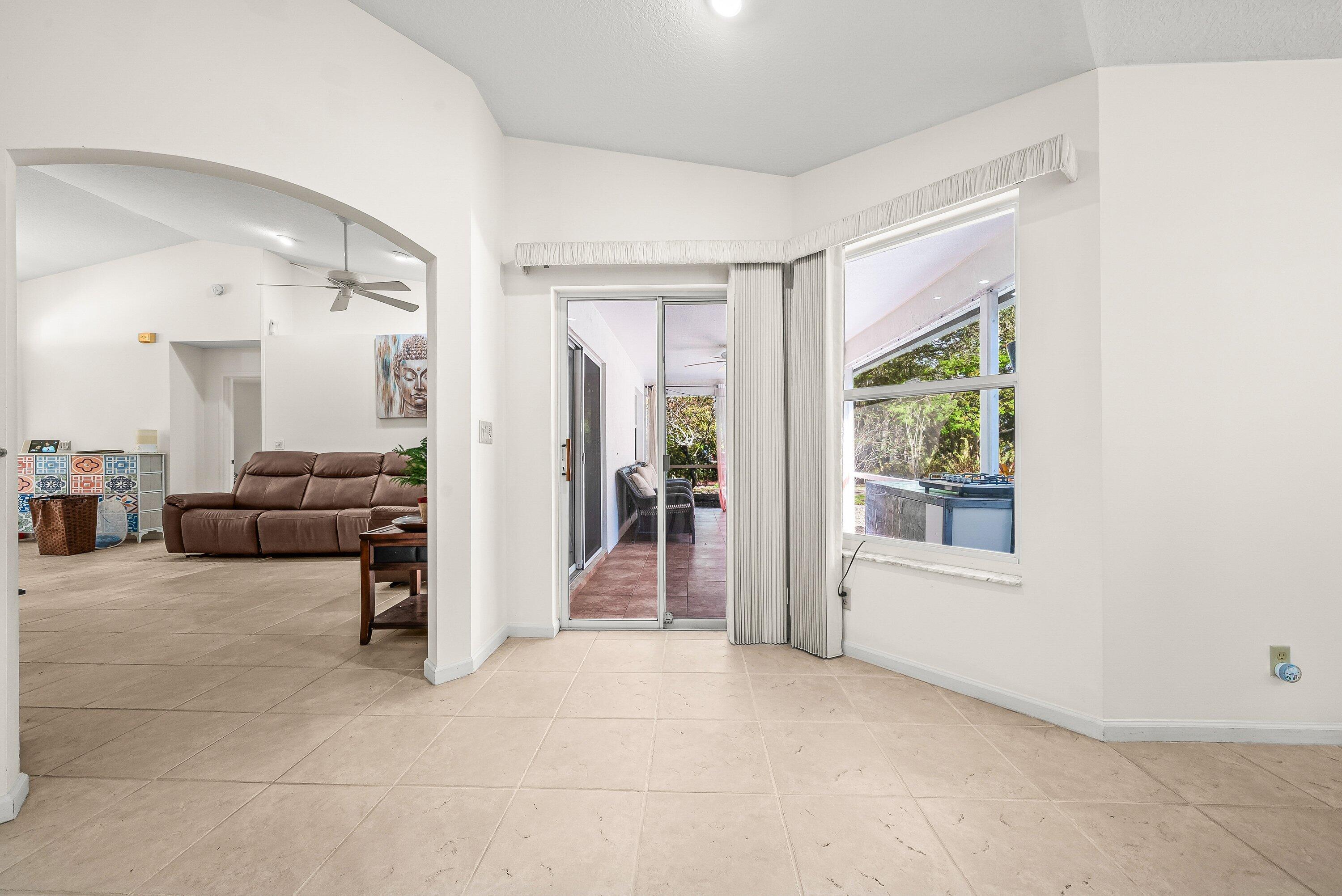 18098 93rd Road North The Acreage, FL 33470 - Photo 10 of 60 a view of a livingroom with furniture and front door
