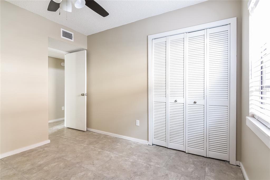 3211 Timberline Road Winter Haven, FL 33880 - Photo 11 of 15 an empty room with ceiling fan and window