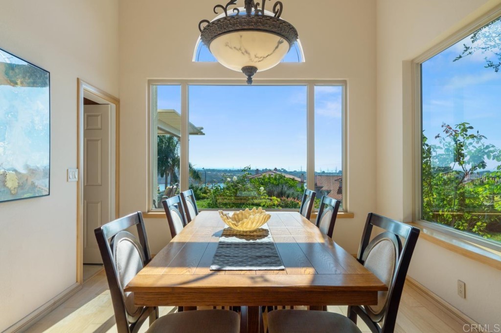 4565 Sea Bluff Circle Carlsbad, CA 92008 - Photo 11 of 62 a view of a dining room with furniture window and wooden floor
