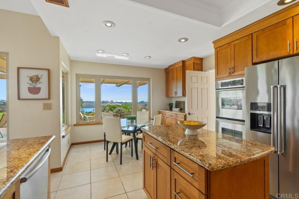 4565 Sea Bluff Circle Carlsbad, CA 92008 - Photo 20 of 62 a dining hall with stainless steel appliances granite countertop a granite counter tops and a view of living room