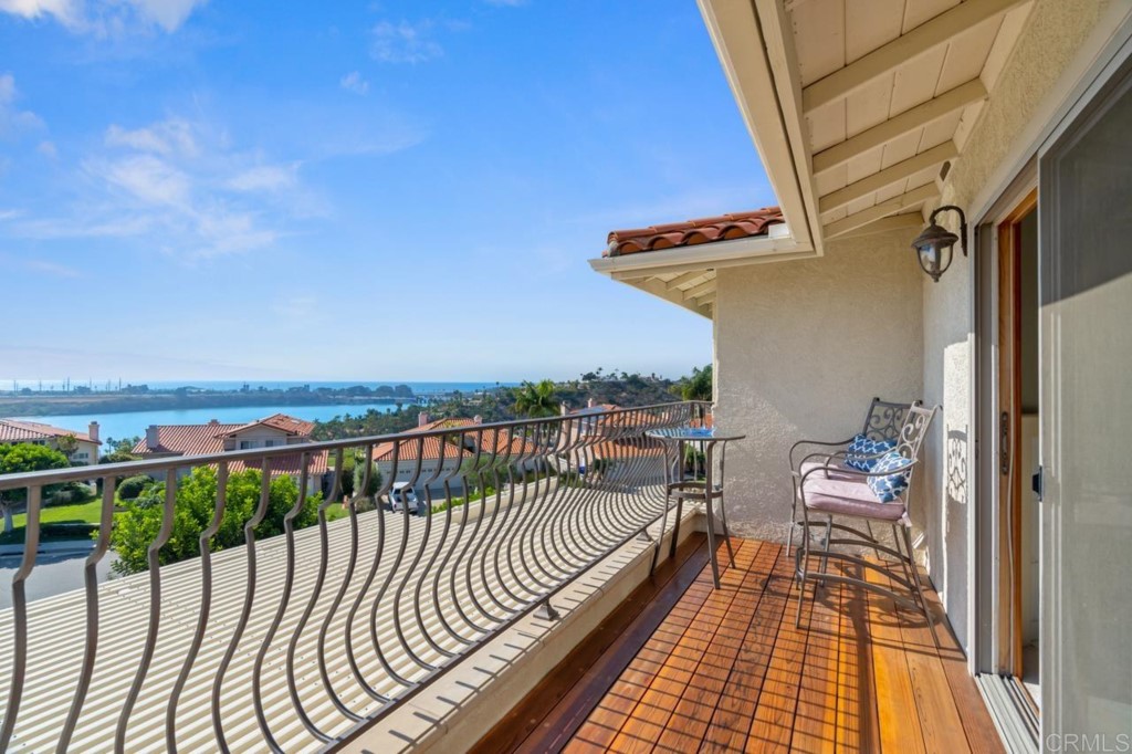4565 Sea Bluff Circle Carlsbad, CA 92008 - Photo 30 of 62 a balcony with wooden floor and furniture