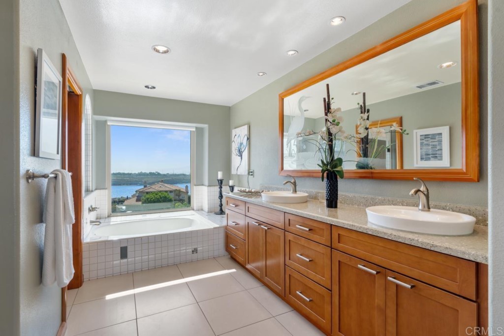 4565 Sea Bluff Circle Carlsbad, CA 92008 - Photo 32 of 62 a spacious bathroom with a tub sink and mirror