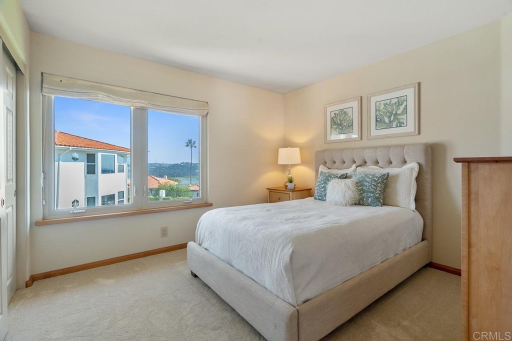 4565 Sea Bluff Circle Carlsbad, CA 92008 - Photo 37 of 62 a bedroom with a large bed and a large window