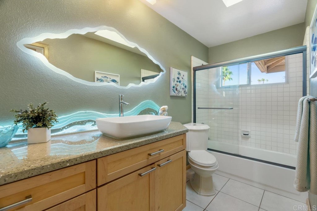 4565 Sea Bluff Circle Carlsbad, CA 92008 - Photo 39 of 62 a bathroom with a granite countertop sink a toilet and shower