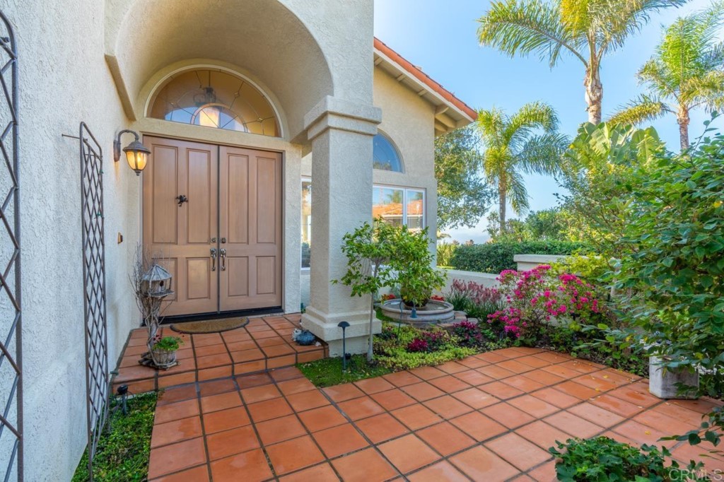 4565 Sea Bluff Circle Carlsbad, CA 92008 - Photo 4 of 62 a front view of a house with a garden
