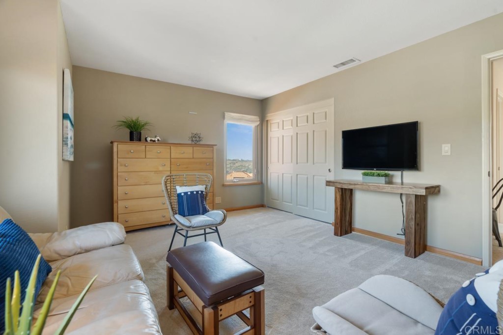 4565 Sea Bluff Circle Carlsbad, CA 92008 - Photo 42 of 62 a living room with furniture and a flat screen tv
