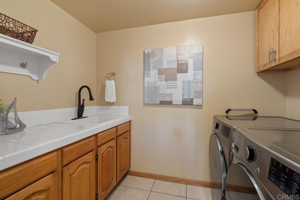 4565 Sea Bluff Circle Carlsbad, CA 92008 - Photo 47 of 62 a kitchen with a sink and cabinets