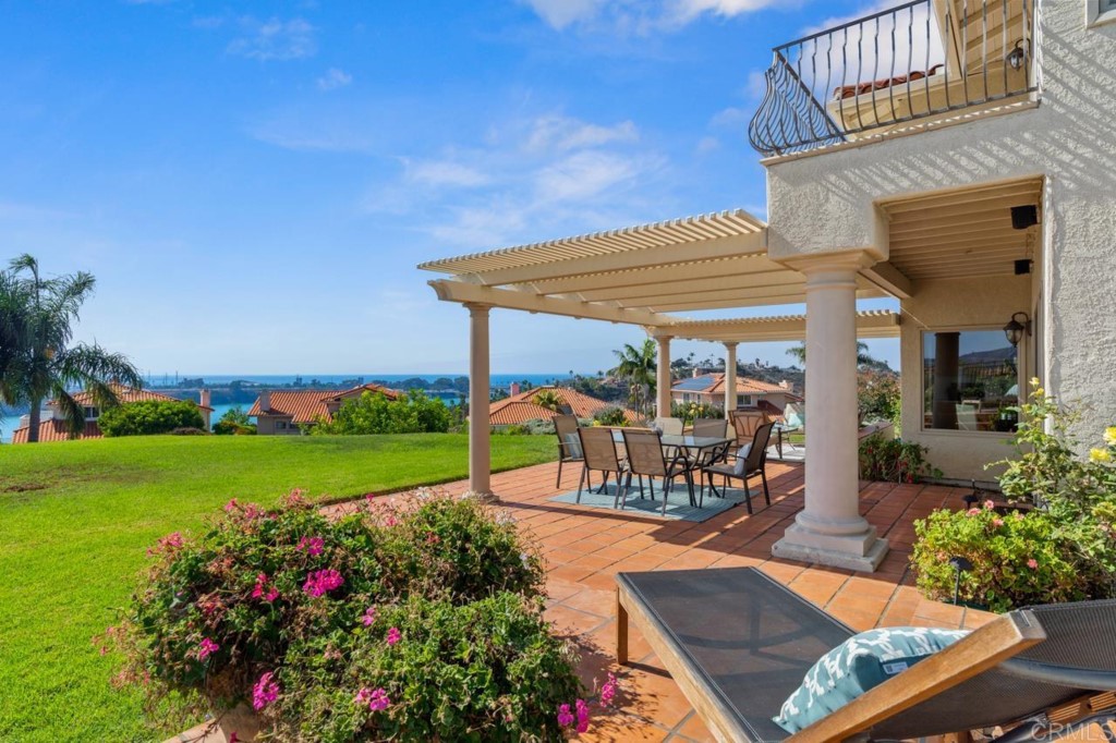 4565 Sea Bluff Circle Carlsbad, CA 92008 - Photo 51 of 62 a view of a patio with a table and chairs potted plants