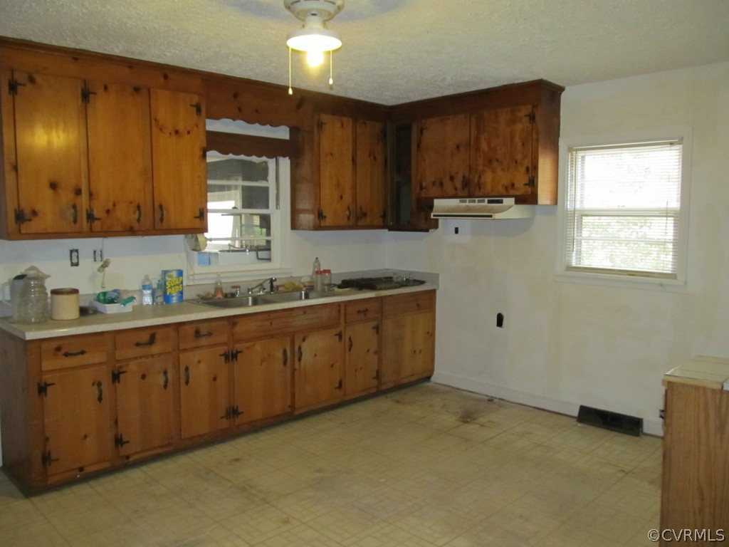 9011 Beach Road Chesterfield, VA 23838 - Photo 10 of 16 a kitchen with granite countertop a sink cabinets and window