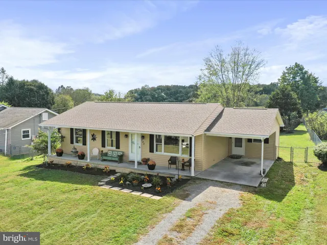 a aerial view of a house with a yard table and chairs