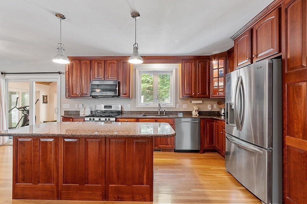 63 Manchester Street Nashua, NH 03064 - Photo 13 of 39 a kitchen with stainless steel appliances granite countertop a refrigerator a sink dishwasher a stove with wooden floor