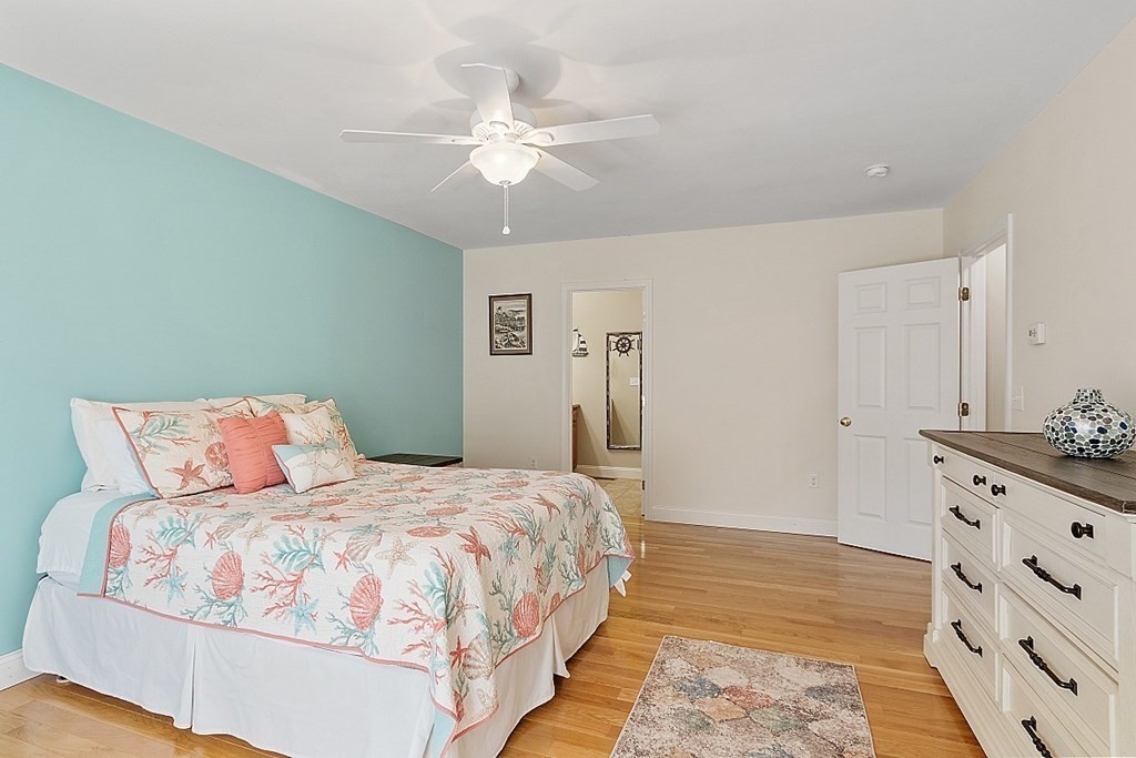 63 Manchester Street Nashua, NH 03064 - Photo 23 of 39 a bedroom with a large bed and a chandelier