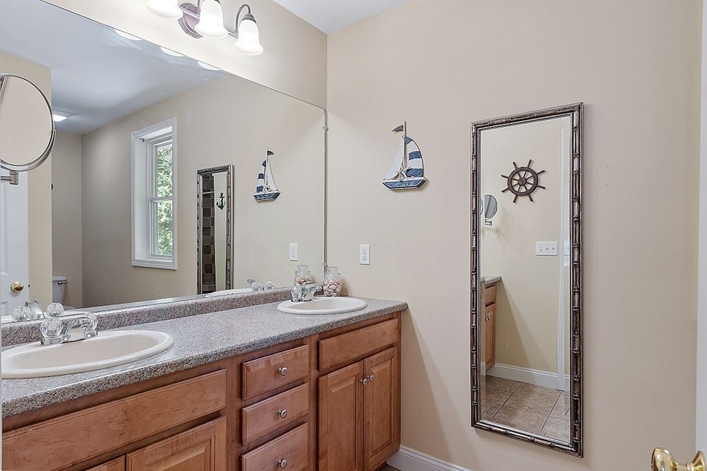63 Manchester Street Nashua, NH 03064 - Photo 25 of 39 a bathroom with a double vanity sink and a mirror