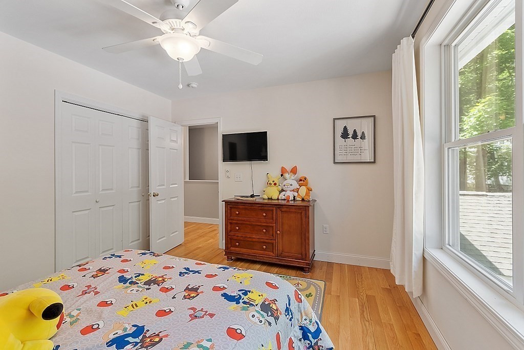 63 Manchester Street Nashua, NH 03064 - Photo 29 of 39 a bedroom with a bed and a dresser in it