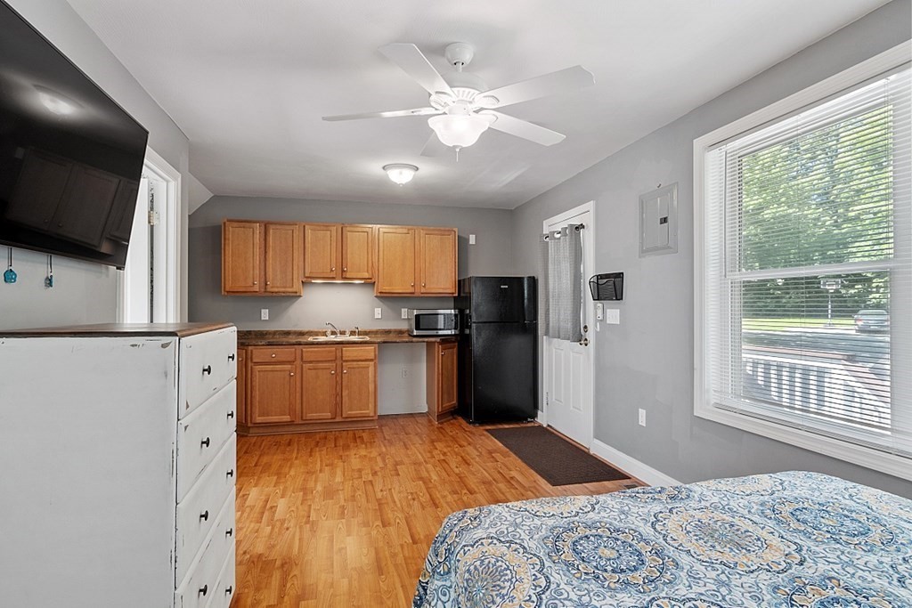 63 Manchester Street Nashua, NH 03064 - Photo 33 of 39 a bedroom with a bed and a flat screen tv