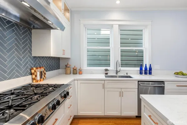 a kitchen with a sink stove and cabinets