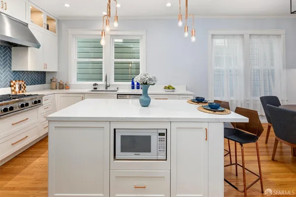 a kitchen with sink cabinets and wooden floor