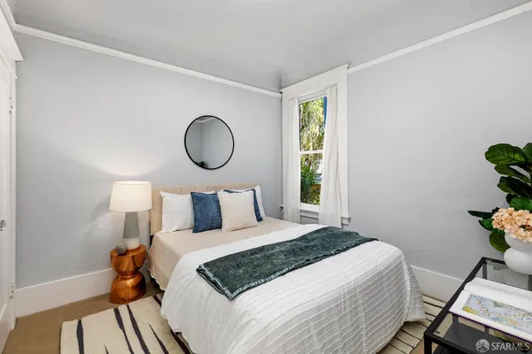 a bedroom with a large bed and a window