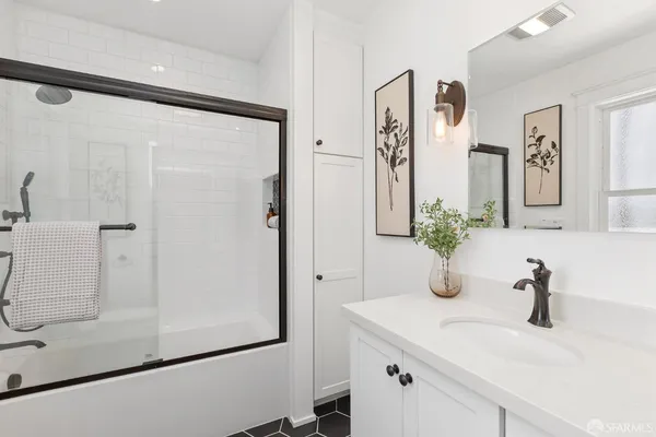 a bathroom with a shower and a sink