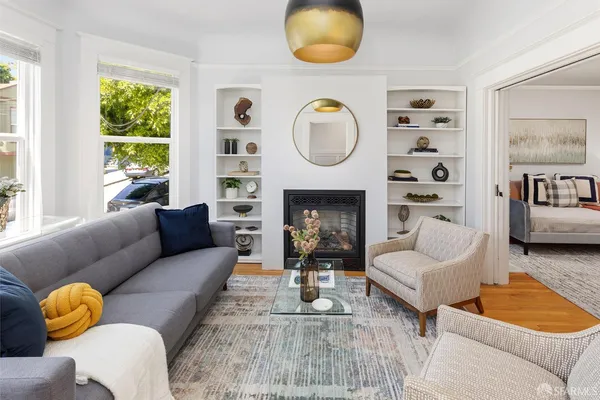 a living room with furniture and a fireplace