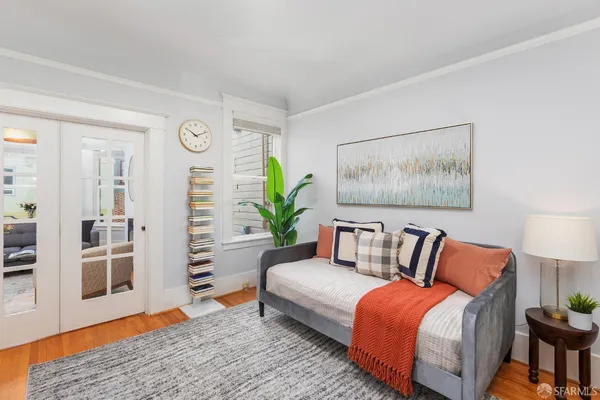 a bedroom with furniture and wooden floor