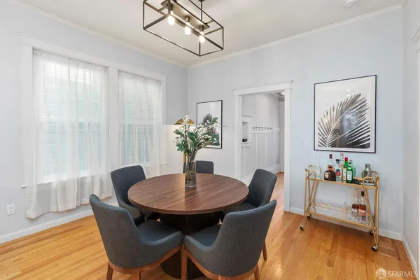 a dining room with furniture and wooden floor