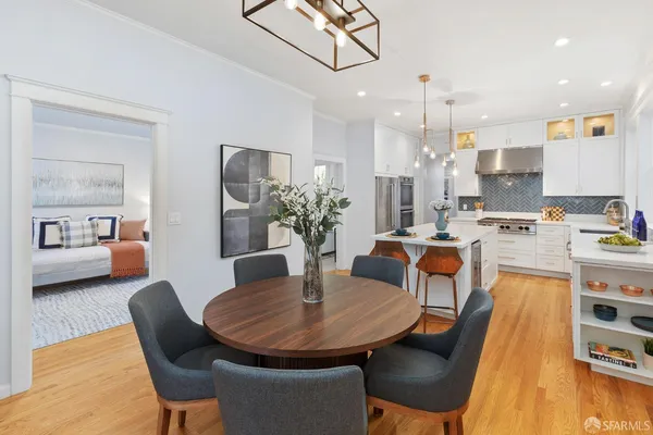 a dining room with furniture a table and chairs