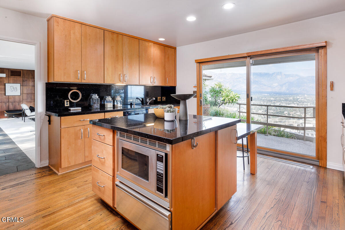 775 Panorama Place Pasadena, CA 91105 - Photo 15 of 62 a kitchen with stainless steel appliances kitchen island granite countertop a stove a sink and white cabinets with wooden floors