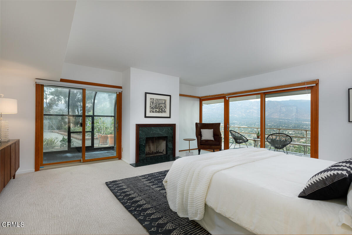 775 Panorama Place Pasadena, CA 91105 - Photo 30 of 62 a large bedroom with a bed and a fireplace