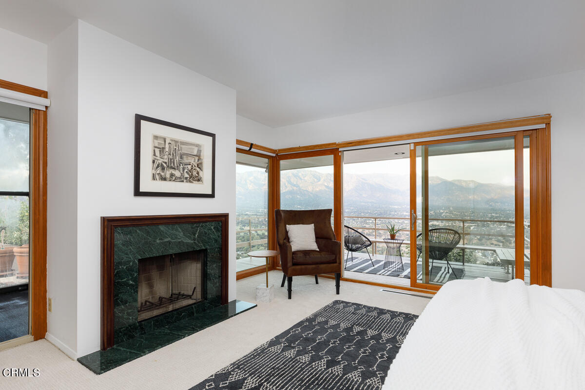 775 Panorama Place Pasadena, CA 91105 - Photo 31 of 62 a living room with furniture a large window and a fireplace