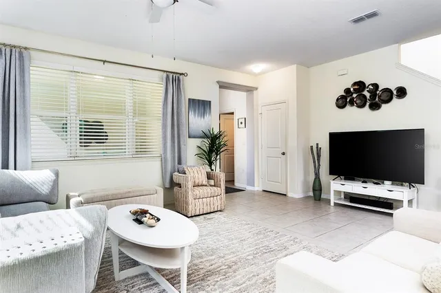 a living room with furniture and a large window