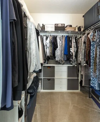 a bathroom with a granite countertop double vanity sink a mirror and a toilet