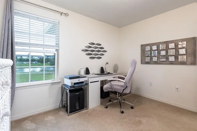 a bathroom with a granite countertop sink a toilet and a mirror
