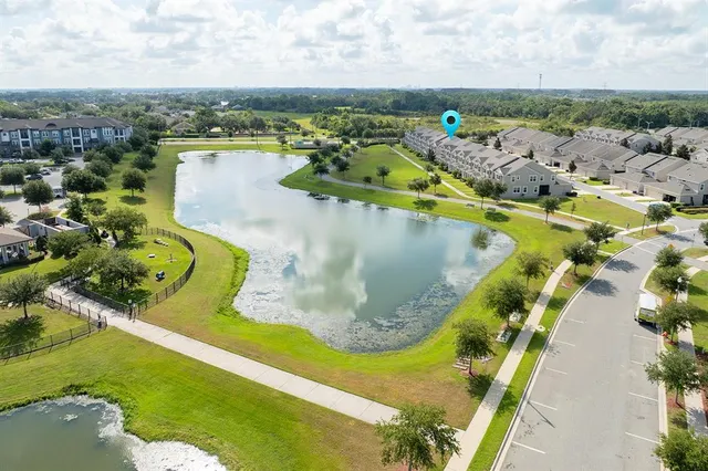 a view of building with swimming pool and green space
