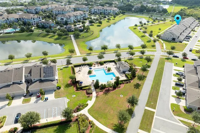 an aerial view of residential house with outdoor space and swimming pool