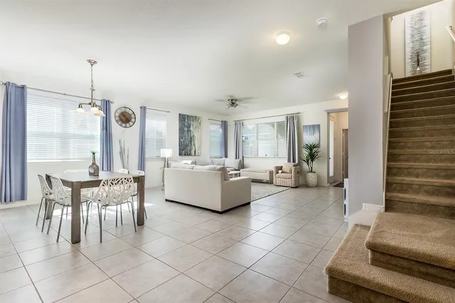 a kitchen with a dining table chairs sink and cabinets